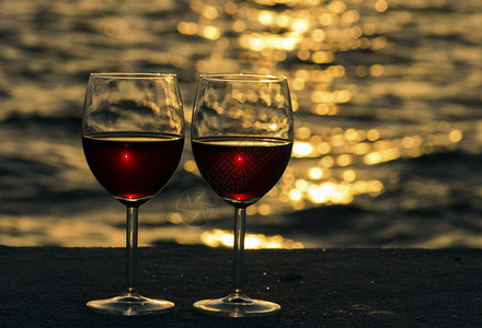 海滩上的一对红酒杯图片