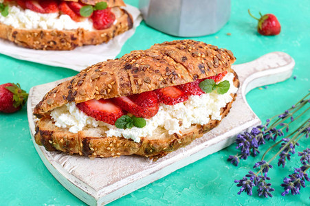 有奶油酪和新鲜草莓的谷物羊角面包有用的早餐适当的营养法国传图片