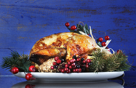 为感恩节或圣诞节午餐配上装饰品的烤火鸡图片