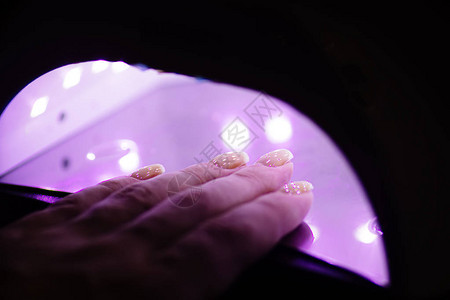 美容院的紫外线灯凝胶油修剪过程图片