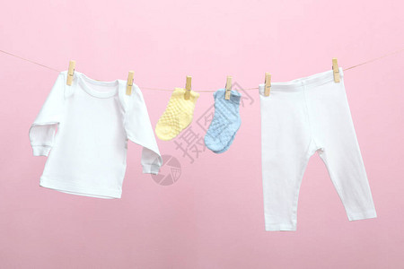 在彩色背景的绳子上的婴儿衣物洗婴图片