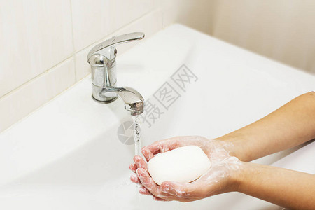 用肥皂在起重机下用水洗手图片