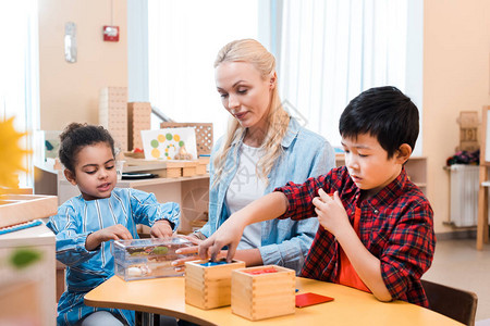 Montessori学校教师有选择地关注儿图片