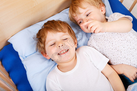 两个小孩男睡前在床图片