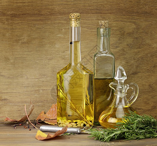 木制背景上的食用油和香料图片