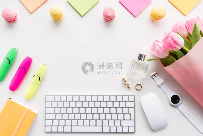 用电脑鼠标键盘粉红色郁金香花束和白色隔离的办公用图片