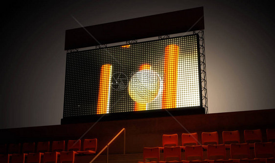 一个发光的体育场大屏幕在夜间在看台上显示板球重播图片