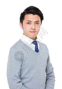 白色背景灰色毛衣的亚洲英俊商人图片