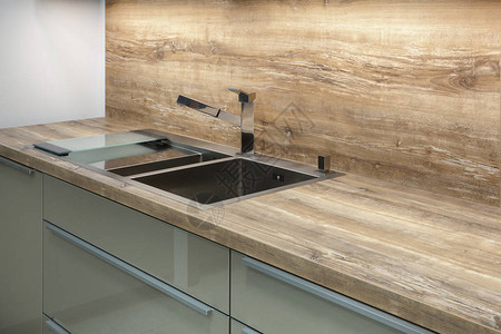 由天然木材制成的桌子顶上不锈钢厨房水槽上的现代设计师图片