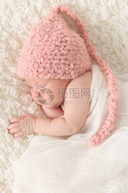 新生女婴裹着老旧的蕾丝戴着粉图片