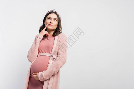 身戴头带的怀孕妇女触摸脸部仰望图片