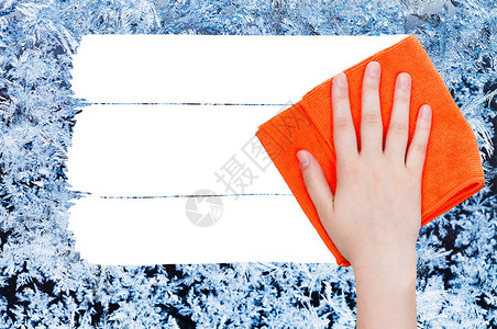 水晶吊灯手从图像上用橙色抹布来删除玻璃上的冬季冷冻纹理背景