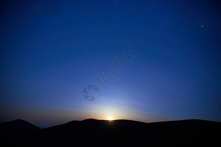 蓝色深夜天空繁星月亮升背景图片