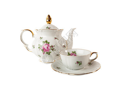 茶壶茶杯和配花岗玫瑰装饰品的碟子图片