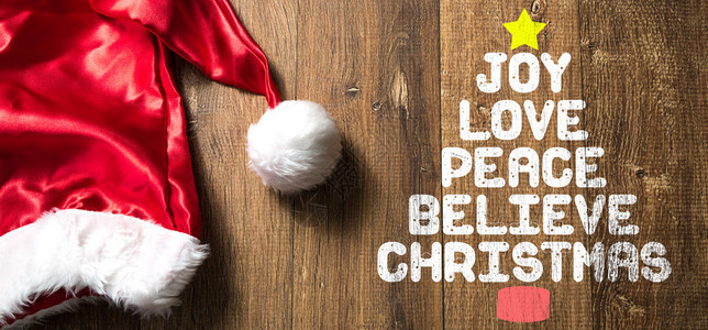 欢乐爱和平相信圣诞节写在木头背景上图片