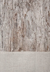 旧质朴木质背景上的亚麻织物图片