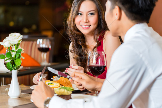 亚裔夫妇男人和女人或者情侣在豪华餐厅调情约图片