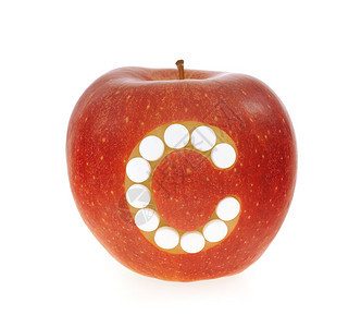 红苹果与维生素c丸在白图片
