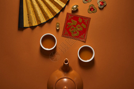 茶叶扇子茶叶象形文字粉丝和棕色传统背景
