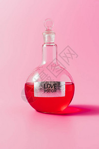 粉红色上装有红色爱情药水的烧瓶特写镜头图片