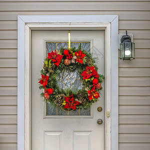 圣诞花环挂在白色的前门上一个美丽的圣诞花环挂在犹他州黎明一户人家的白色木门上外墙上有水平壁图片