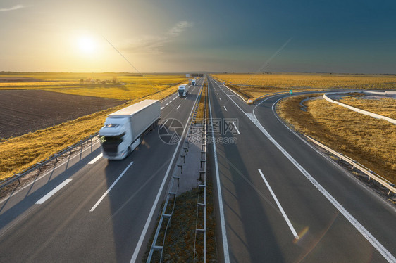 三辆送货卡车驶向在美丽的秋景高速公路上行驶的快速模糊运动塞尔维亚贝尔格莱德附近高速公路图片