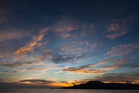 多云天空下宁静的日落海景图片