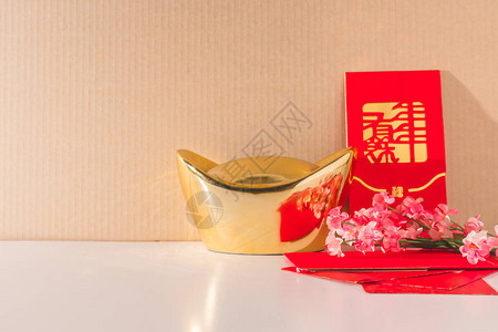 金子红包和梅花放在桌图片