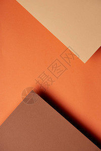棕色和橙色调背景中的纸张图片