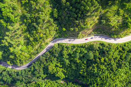 对穿越东南亚热带雨林和山岳的农村道路进行空中观察图片