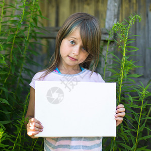 穿着干净白纸的可爱小女孩在户外露宿图片