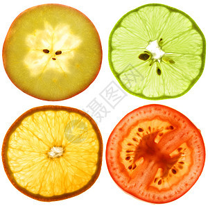 一个成熟的苹果橙子番茄和绿色柠檬的半透明切口图片
