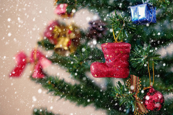 挂在树上并加上雪效应和彩色过滤器的圣诞红亭和装图片