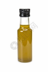 玻璃杯优质处方橄榄油瓶和一些含白种叶片的橄榄图片