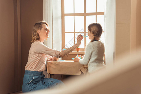茶会妈和小女儿在纸板屋里喝茶背景