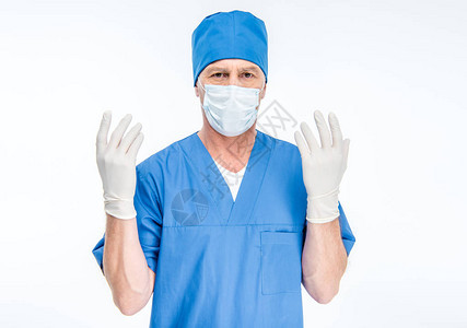 戴面罩和外科手套的成熟男外科医生图片