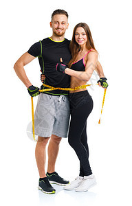 快乐的一对运动夫妇男人和女人用测量胶带和姜汁图片
