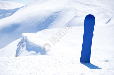 在欧洲背景雪山的雪中滑雪板图片