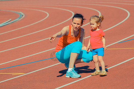 母亲和小女儿在体育场周围跑步和运动训练孩子在体图片