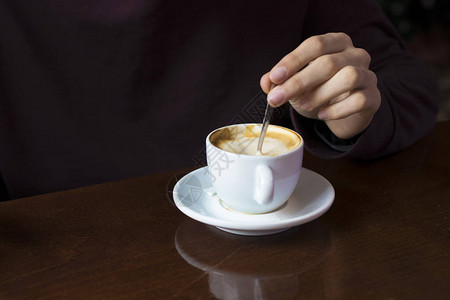 前景中有咖啡杯的手背景图片