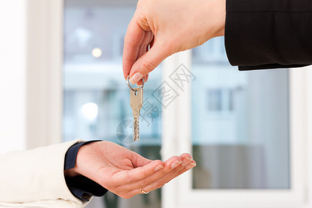 年轻的房地产商把公寓钥匙给房客锁上钥图片