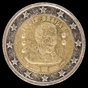 2009年比利时发行的纪念盲文字母发明者路易斯布莱叶200周年纪念币在黑色背景背景图片