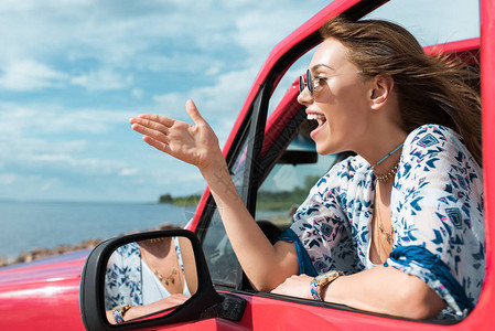 快乐的年轻女子在旅途中驾背景图片