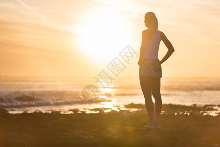 沉思的感的金发女人在海滩图片