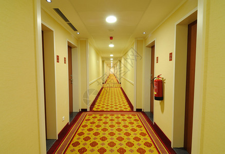 在酒店里有一排套房的走廊图片
