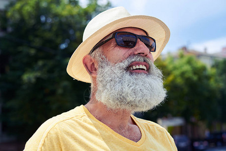 近距离拍摄着微笑的长胡子老人戴着图片