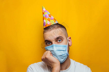 戴着医用口罩的年轻白种人庆祝他的生日图片