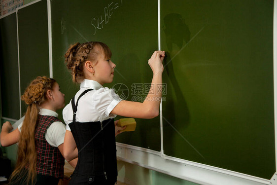 女学生用粉笔在黑板上写图片