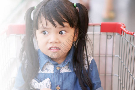 亚洲儿童可爱或小女孩穿着有趣和笑话的牛仔裤或令人震惊的面孔图片