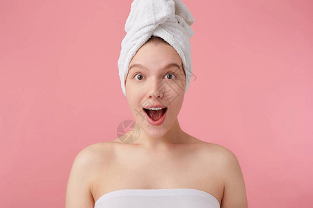 年轻快乐惊讶的女人在淋浴后头戴毛巾图片